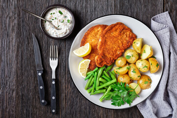 German pork schnitzel with potato and green beans