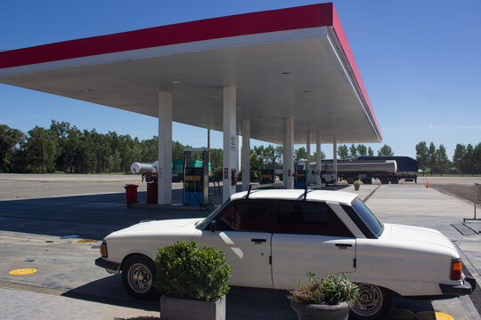 Parked car in an old gas station on the highway