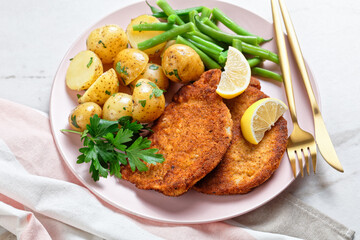 Breaded pork schnitzel with potatoes, green beans