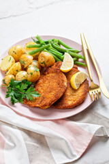 Breaded pork schnitzel with potatoes, green beans