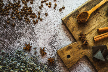 coffee, chocolate, cinnamon and spices on a brown wooden board 6