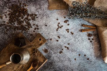 coffee, chocolate, cinnamon, lavender and spices on a brown wooden board