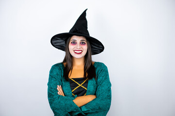 Woman wearing witch costume over isolated white background crossed arms looking at the camera smiling