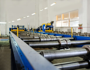 Interior of metal tile roof factory. Metal tile roof profiling manufacturers.