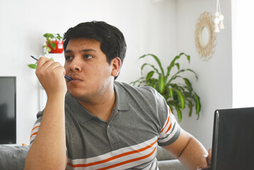 adult man with black hair and gray shirt making different expressions in front of a computer and cell phone