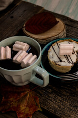 autumn atmosphere tea and coffee with a delicious cake on a wooden background