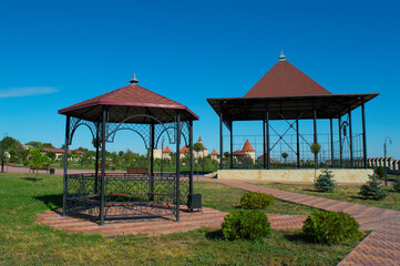 Two openwork gazebos for recreation of various forms in the park area. Making beautiful traditional wrought iron structures. Types of roofs and roof coverings, construction.