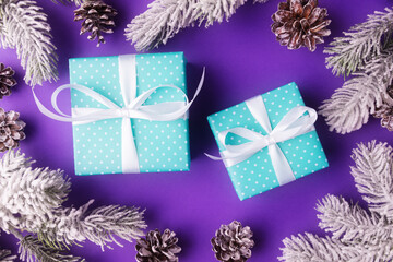 Christmas background with blue gift boxes and frosty fir tree branches. Xmas and New Year concept