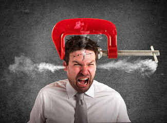 Businessman with a vise on his head. concept of headache
