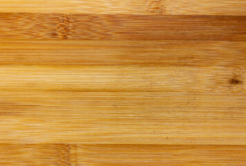 Fototapeta premium Texture Of Wooden Board Made Of Bamboo. Background Photo Of Texture Of Wooden Chopping Board Made Of Bamboo. Kitchen cutting Board made of bamboo. Board made of natural bamboo wood.