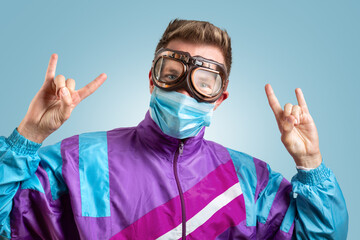 Funny portrait of a young man with goggles and mask going crazy