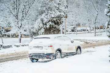 car covered with snow on the side of the road