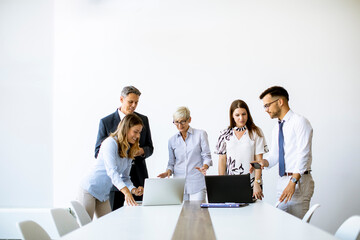 Senior businesswoman working together with young business people in office