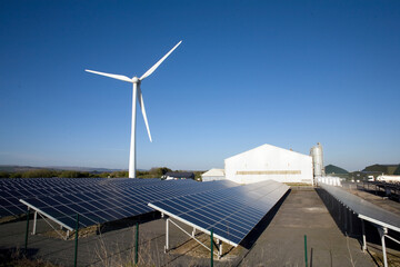 Three types of renewable electricity generation on Newton Down, wind turbine, solar panels and, in the shed, anaerobic digestion, Newton Down, Porthcawl, South Wales, United Kingdom
