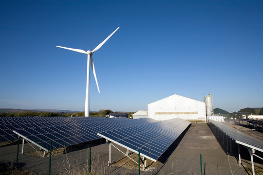 Three types of renewable electricity generation on Newton Down, wind turbine, solar panels and, in the shed, anaerobic digestion, Newton Down, Porthcawl, South Wales, United Kingdom