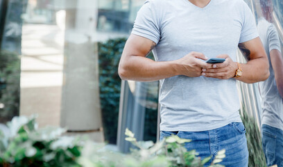 Mobile phone in men's hands. A man writes a message on a cell phone.