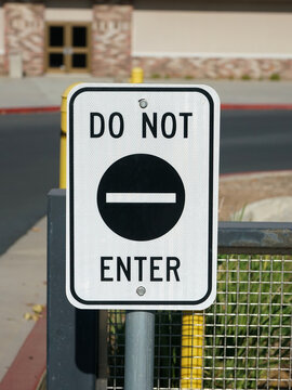 Black Do Not Enter Sign on Pole