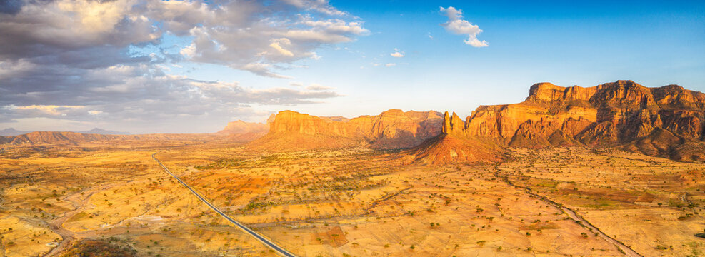 Aerial panoramic by drone of road at foot of Gheralta Mountains canyons, Hawzen, Tigray Region, Ethiopia