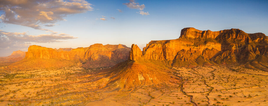 Aerial panoramic by drone of Gheralta Mountains lit by sunset, Hawzen, Tigray Region, Ethiopia