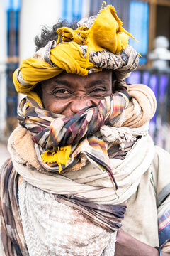 Portrait of young man with headwrap smiling at camera, Bati, Amhara Region, Oromia, Ethiopia