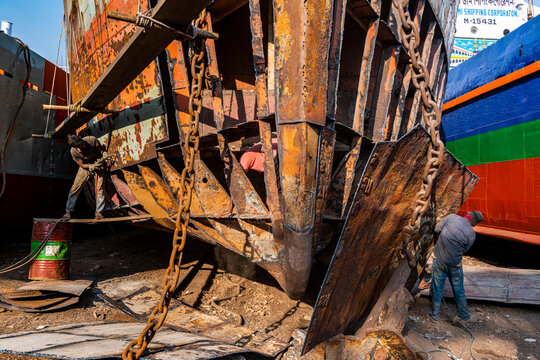 Men at an open boat, shipwreck cemetery (ship breaking yard), Port of Dhaka