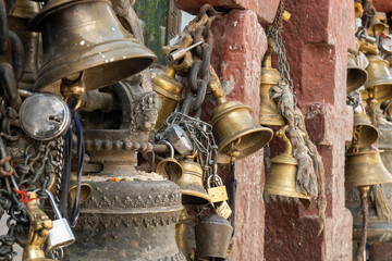 Fototapeta premium Old cast iron, copper and bronze bells held together with metal chains and locks.