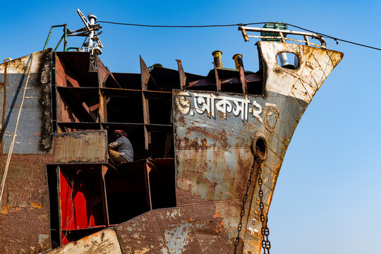 Man welding on a ship, shipwreck cemetery (ship breaking yard), Port of Dhaka
