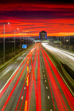Red sky sunset, traffic light trails, M8 Motorway, Scotland, United Kingdom