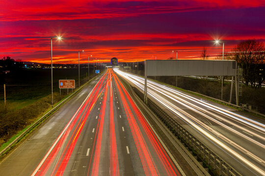 Red sky sunset, traffic light trails, M8 Motorway, Scotland, United Kingdom