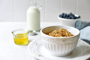 Homemade granola with milk,fresh berries and honey.