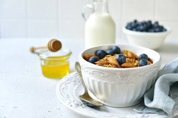 Obraz na płótnie Canvas Homemade granola with milk,fresh berries and honey.