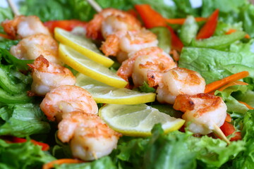 Delicious shrimp skewers on a fresh vegetables