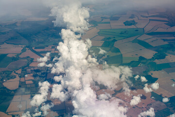 View from the plane to the ground and clouds. Travel concept.