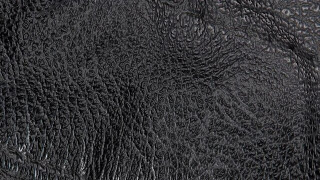 animated black leather background. a piece of black leather with folds. 3d render
