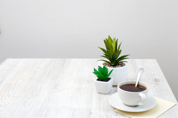 Office desk wood table of Business work place, artificial plants and coffee cup
