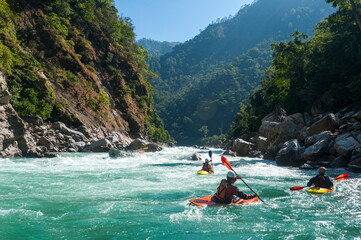 Kayakers negotiate their way through whitewater rapids on the Karnali River in west Nepal