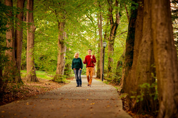 Beautiful woman,blonde,middle-aged,with a big son walking in the Park,a beautiful autumn day