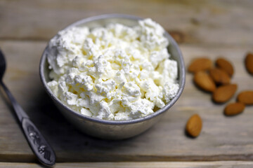 Selective focus. Macro. A bowl of cottage cheese and almonds. Healthy food concept. Diet lunch or breakfast. The keto diet.
