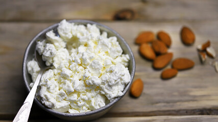 Selective focus. Macro. A bowl of cottage cheese and almonds. Healthy food concept. Diet lunch or breakfast. The keto diet.