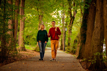 Fototapeta premium Beautiful woman,blonde,middle-aged,with a big son walking in the Park,a beautiful autumn day