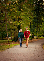 Beautiful woman,blonde,middle-aged,with a big son walking in the Park,a beautiful autumn day