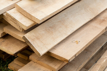 building material a stack of old beige boards stacked for building a house