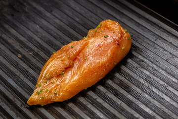 Chicken breast is grilled in a restaurant