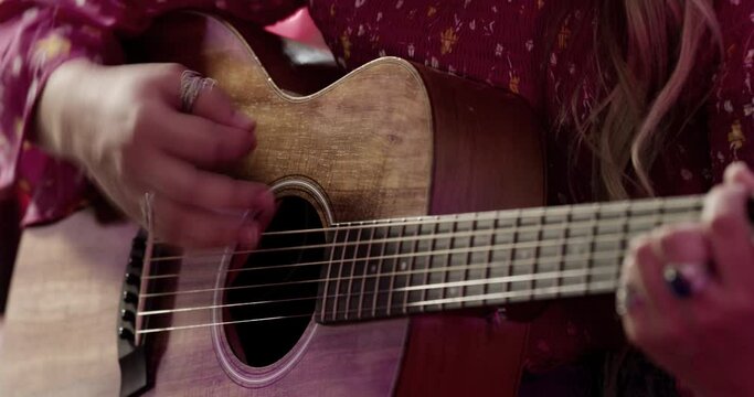 Woman Playing Guitar and Singing.