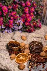 set for cozy autumn. cozy autumn. cup of tea, chocolate cookies, candle, cinnamon, anise, nuts on white knitted sweater. Hygge lifestyle