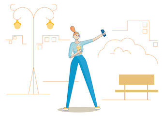 Girl makes selfie in the city. She drinks coffee.