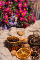 set for cozy autumn. cozy autumn. cup of tea, chocolate cookies, candle, cinnamon, anise, nuts on white knitted sweater. Hygge lifestyle