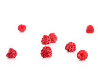 Fresh Raspberries on white reflective background. Isolated