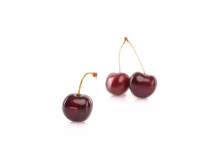 Fresh cherries on white reflective background. Isolated