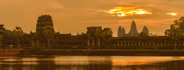 Sunrise in Angkor Wat temple, Siem Reap, Cambodia. Panoramic landscape with juicy colorful yellow,...